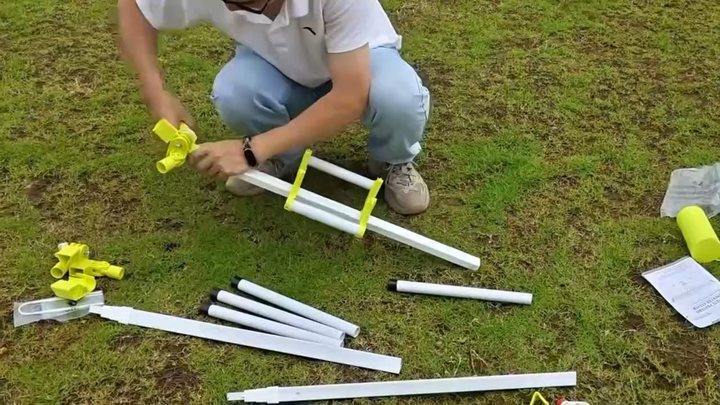 A yellow end hub being pushed onto the end of the square base rail