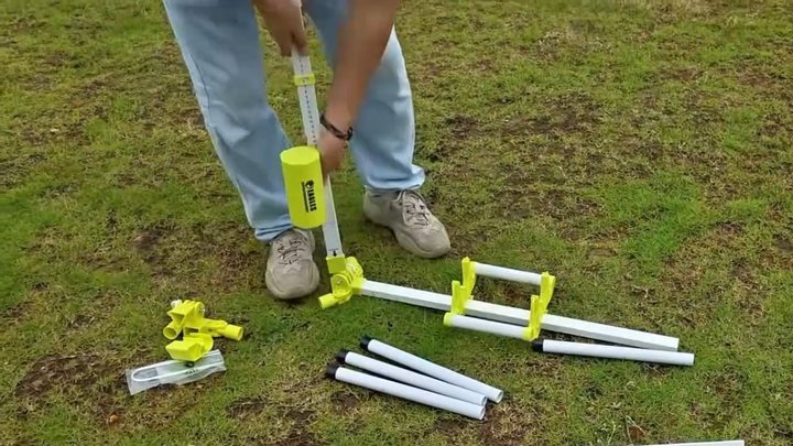 A telescoping square side-post assembly being installed into a yellow end hub