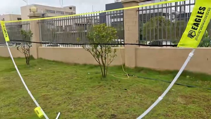 Completed EAGLES badminton net standing on grass